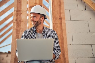cheerful-young-architect-using-his-laptop-outdoors-2024-10-18-09-28-11-utc (1)