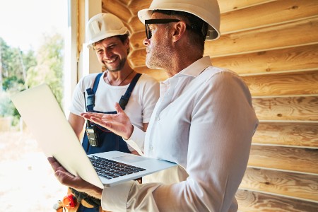 civil-engineer-with-laptop-explaining-something-to-2023-11-27-04-55-56-utc