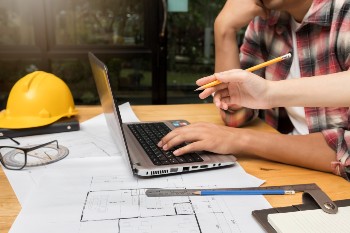 group-of-two-coworkers-working-with-blueprint-in-o-2023-11-27-05-18-27-utc